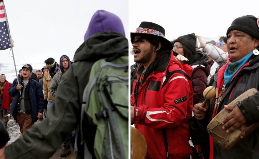 Protestors including Fish Water, 53, (left, center) and Dan Nanamkin, 49, of the Nez Perce Nation (right, center) participate in a prayer march out of the Oceti Sakowin camp ahead of the evacuation deadline.