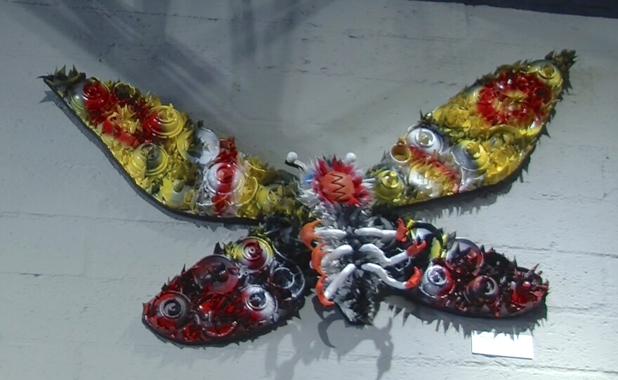 Optimus Volts' three-dimensional Mothra made from recycled materials and broken spray paint cans.