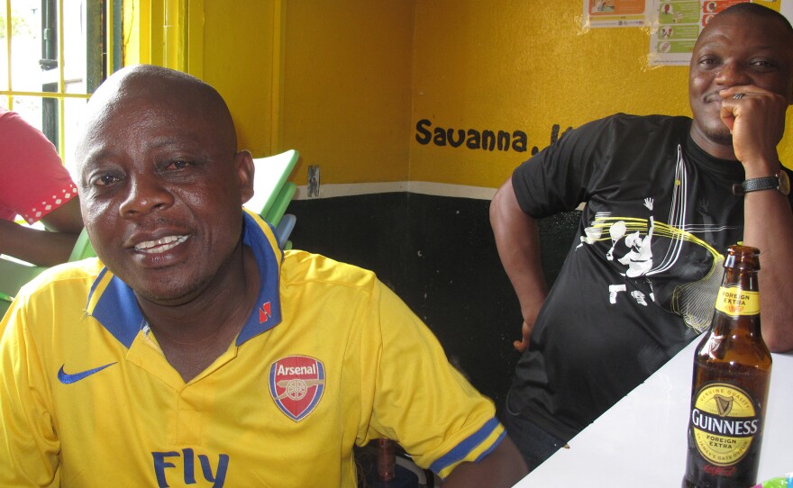 Antonio Francis Tuan (front), a lawyer, relaxes with his friends at a sports bar — though he makes sure not to sit too close to other patrons.