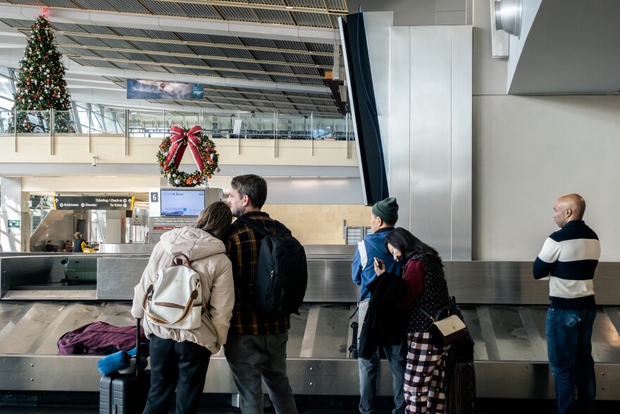 Passengers from United Flight 2066 wait at baggage claim before heading off into San Diego for the sunny holiday, San Diego International Airport. Dec. 23, 2022. Holiday travel is in full swing at the San Diego International Airport. Thousands are flying out of San Diego and California and just as many are flying into San Diego for the holidays.