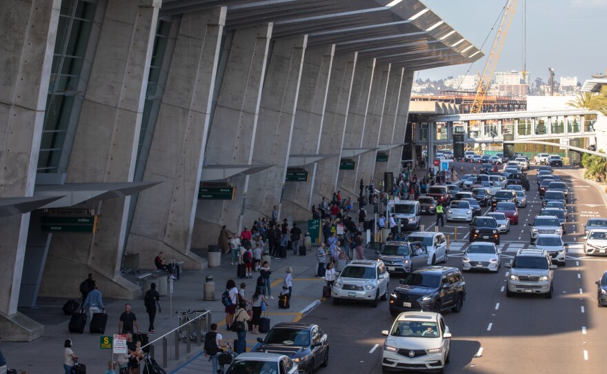 Drivers pick up passengers outside of the arrivals area at San Diego International Airport, July 28, 2023.
