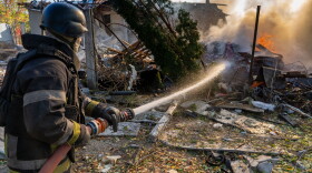 A rescue worker puts out a fire at residential houses destroyed in a Russian strike on Kharkiv, Ukraine, Sunday, Oct. 11, 2026.