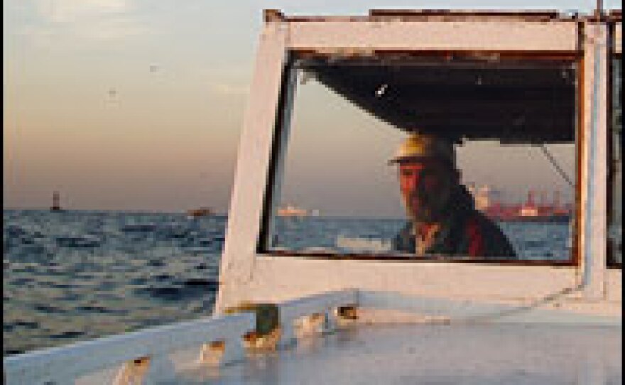 Gelgit, a second-generation fisherman, trolls for mackerel in the Bosporus strait. Gelgit says his father didn't have a motorboat. He had to row out to sea.