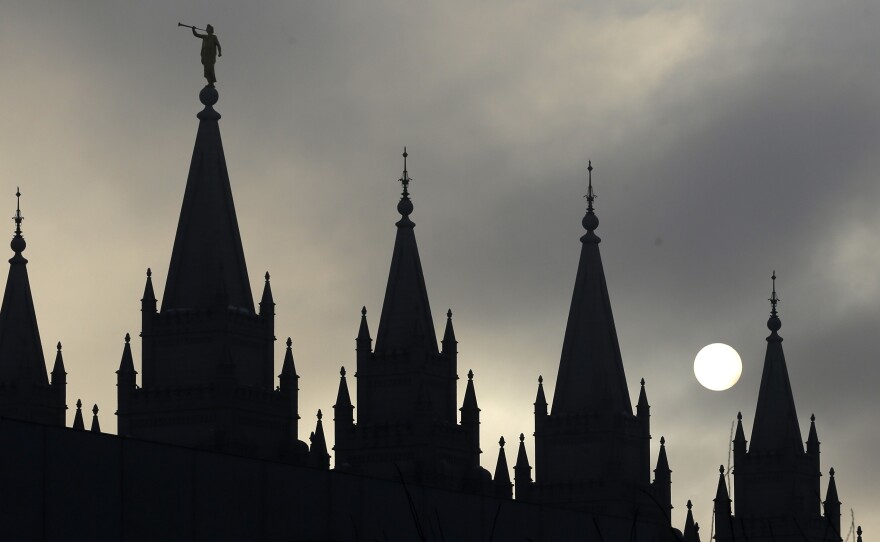 In this photo taken February 2013 photo, the statue of the angel Moroni sits atop the Salt Lake Temple, in Salt Lake City. Hundreds of Mormons have resigned their memberships in the church in protest of a new policy aimed at children of same-sex couples.