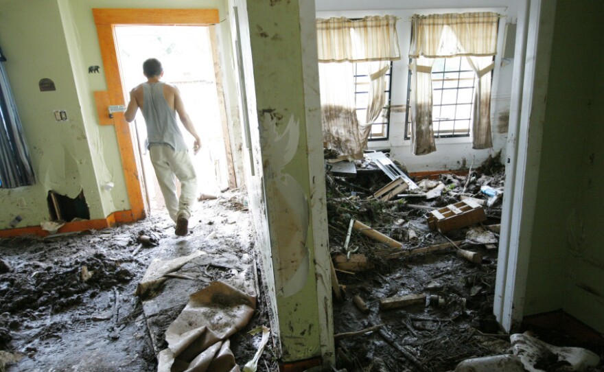 Justin Mudge walks through the muddy interior of his great uncle's gun shop, destroyed by flooding caused by Irene on Sept. 1 in Prattsville, N.Y. FEMA will run out of money to help disaster victims by early next week unless Congress acts.