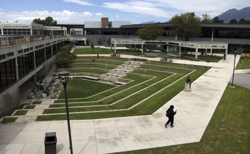 People walk near the site where conservative commentator Charlie Kirk was killed on the campus of Utah Valley University in Orem, Utah on Aug. 28, 2026.