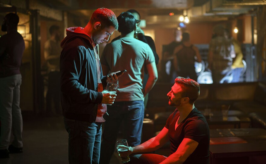 Julian Morris as Adam Berryman (left).