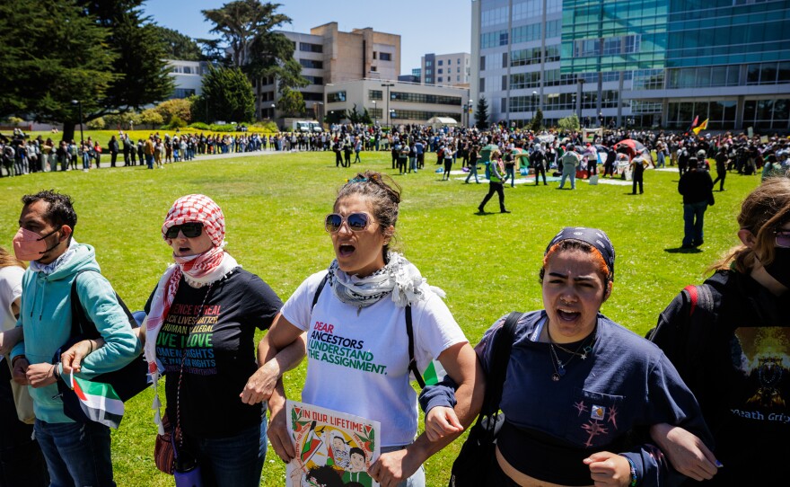 San Francisco State University students stand arm in arm as they assemble an encampment on campus to demand the university to disclose its financial ties to Israel and divest from weapons manufacturers at SFSU on April 30.
