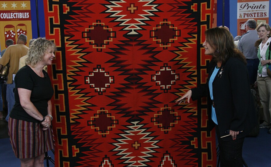 Linda Dyer (right) appraises a Navajo Germantown weaving, ca. 1890, in Philadelphia, Pa. 