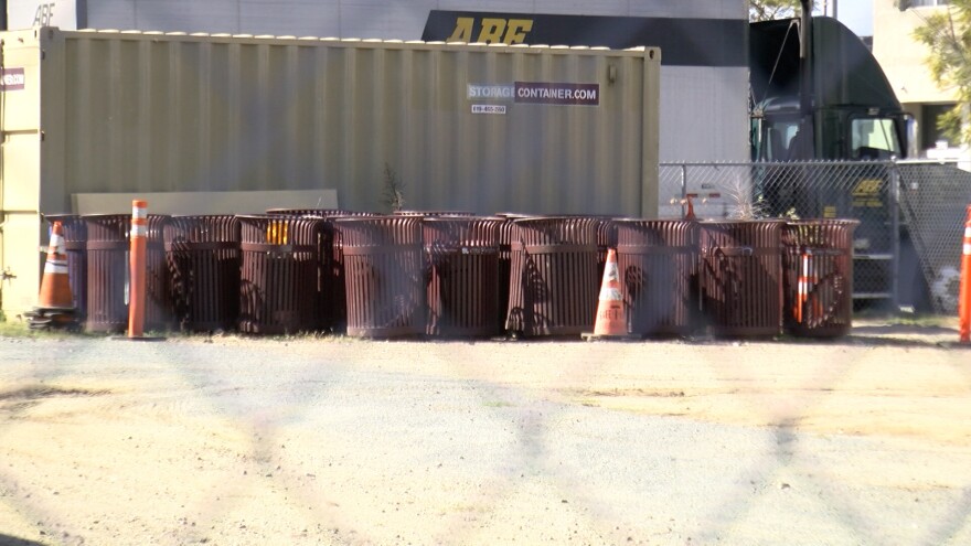 City Heights Business Association trash cans sit in an empty lot on University Avenue, Feb. 16, 2022.