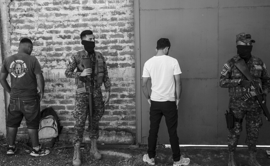 Young people are arrested by security forces patrolling Soyapango during a crackdown against gangs on Dec. 3, 2022.