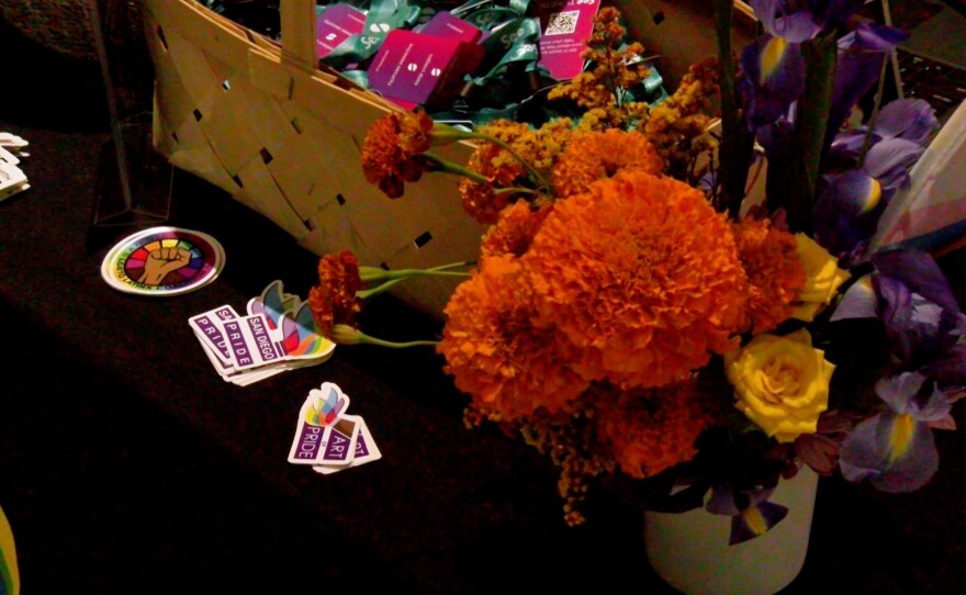 Flowers and San Diego Pride swag are shown on a registration table in the lobby of the Westin Gaslamp on Oct. 26, 2023.