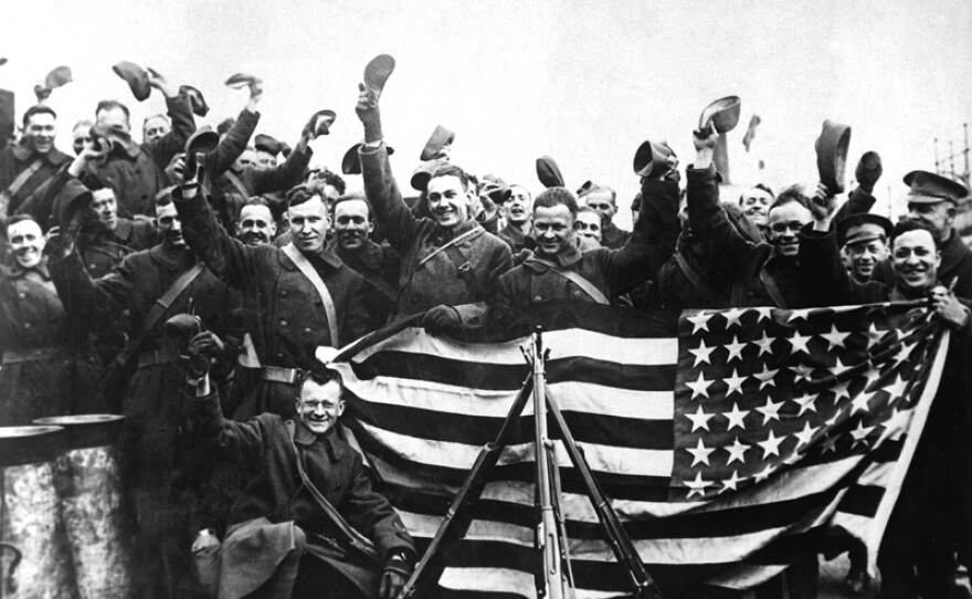 American troops cheering with U.S. flag in Russia at the end of the war (circa 1919).