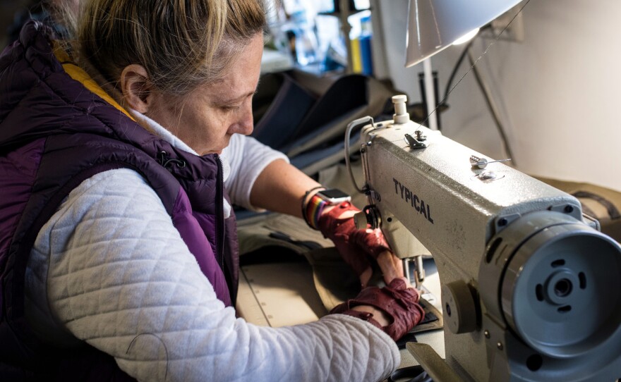 Elena Grekova sews a vest into which steel plates can be inserted to complete a set of body armor. Prior to the Russian invasion, she was a fashion designer who sold her creations in boutiques in Kyiv.