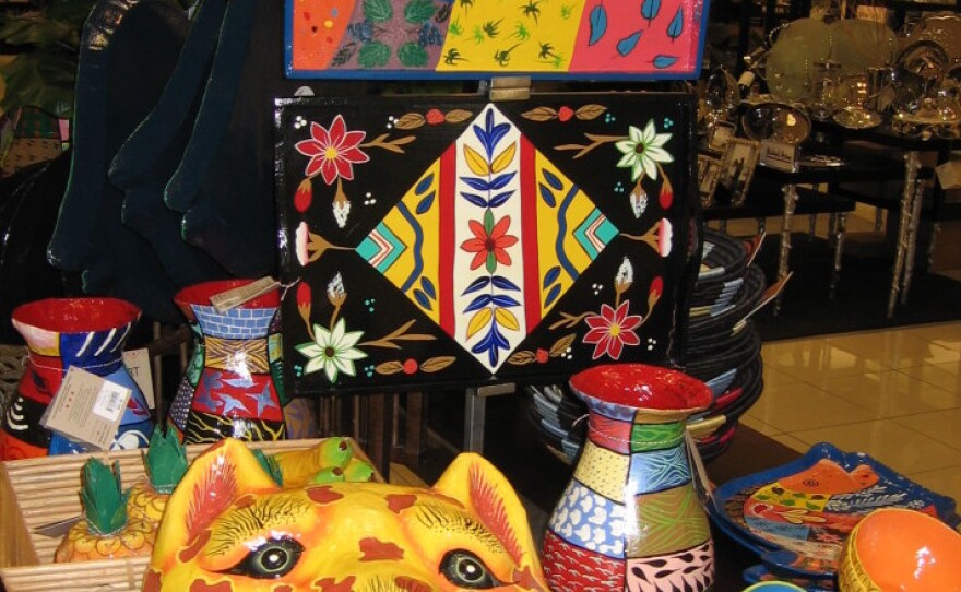 The "Heart of Haiti" collection, as shown in a display at Macy's in Miami, includes colorful trays, vases and other housewares — all created by Haitian artisans.