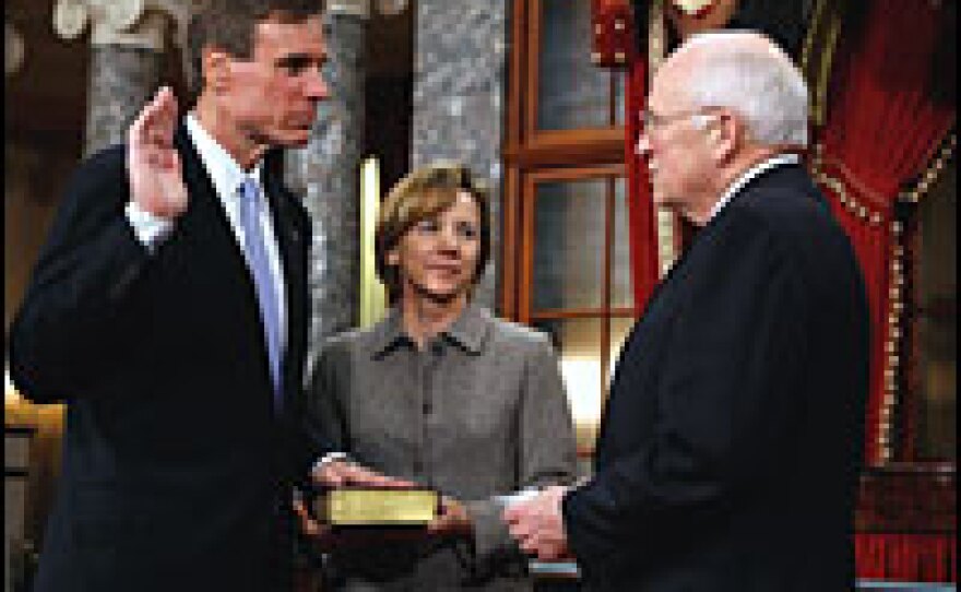 Democrat Mark Warner of Virginia (left) stands with his wife, Lisa Collis, and Vice President Dick Cheney during a mock swearing-in ceremony Tuesday on Capitol Hill.