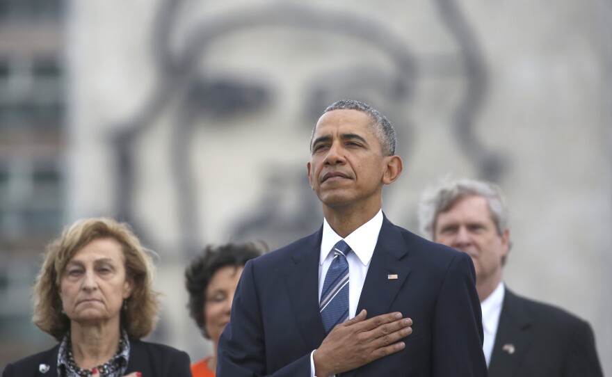 President Obama listens to the U.S. national anthem in Havana on March 21. Behind him is an image of Cuba's revolutionary leader Ernesto "Che" Guevara.