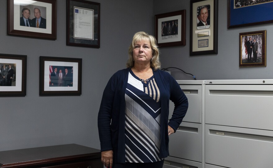 Michelle Voorheis is surrounded by political mementos in her property management office in Clio, Michigan.