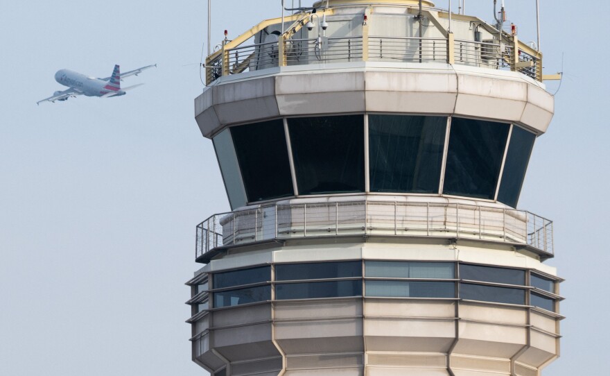 An American Airlines Airbus A319 airplane takes off past the air traffic control tower at Ronald Reagan Washington National Airport in Arlington, Va., in January.