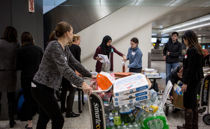 Volunteer attorneys at Washington Dulles International Airport in D.C. set up a temporary workstation near the baggage claim.