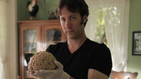Dr. David Eagleman holding a human brain, donated to The M.I.N.D. Institute, University of California at Davis Medical Center for science research.