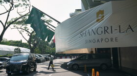 A man walk near the entrance of the Shangri-La Hotel, the venue for the International Institute for Strategic Studies (IISS) Shangri-La Dialogue, Asia's annual defense and security forum, in Singapore, Thursday, May 28, 2026.