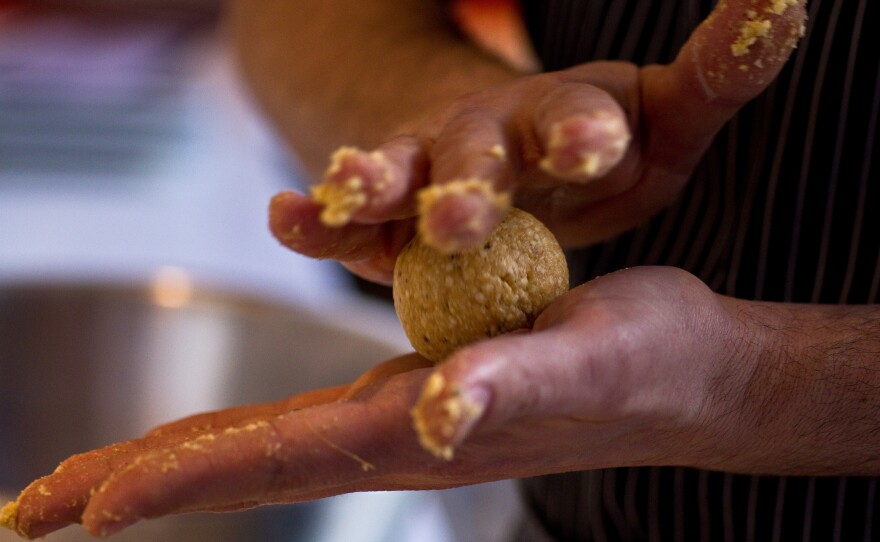 Barry Koslow, chef of DSG deli, demonstrates the proper technique for rolling a matzo ball. He has updated the traditional Passover meal with ingredients such as boiled bone marrow.