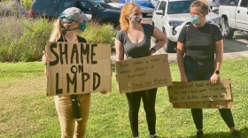 Isabella Lawrence, center, is pictured at at recent protest.