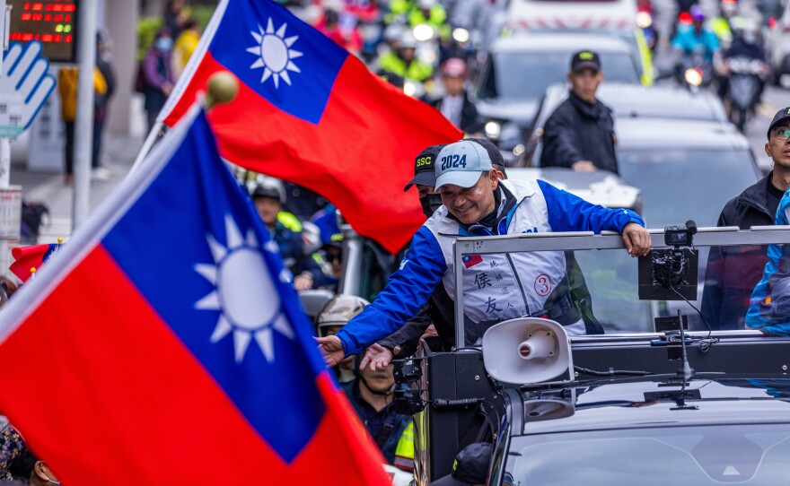 KMT presidential candidate Hou Yu-ih shakes hands with supporters during an election campaign on January 4.