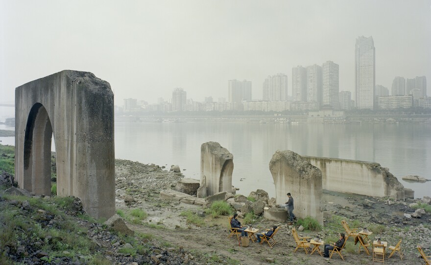 Zhang Kechun; Under the Abandoned Pier, 2013-2014. Zhang, 34, spent years shooting photos along the Yellow River. The figures are tea sellers.