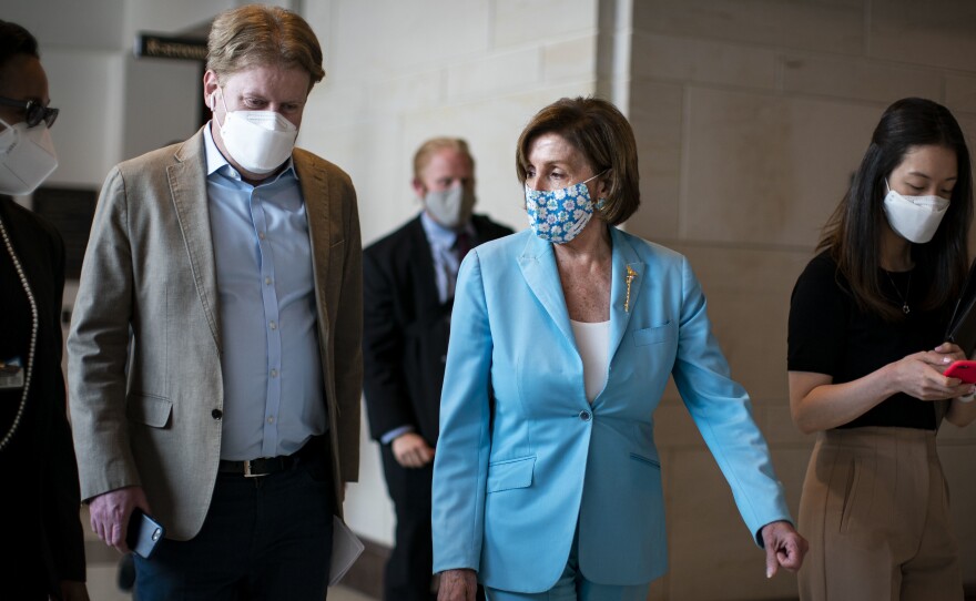House Speaker Nancy Pelosi, D-Calif., wears a mask as she departs a news conference at the U.S. Capitol on Wednesday.