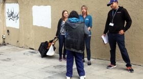 Mindy Coughlin, left, and Heidi Unruh, center, both San Diego County Health and Human Services Agency Public Health Nurses and an outreach worker from Friend to Friend talk to a homeless person about getting the hepatitis A vaccination in downtown San Diego in this undated photo. 