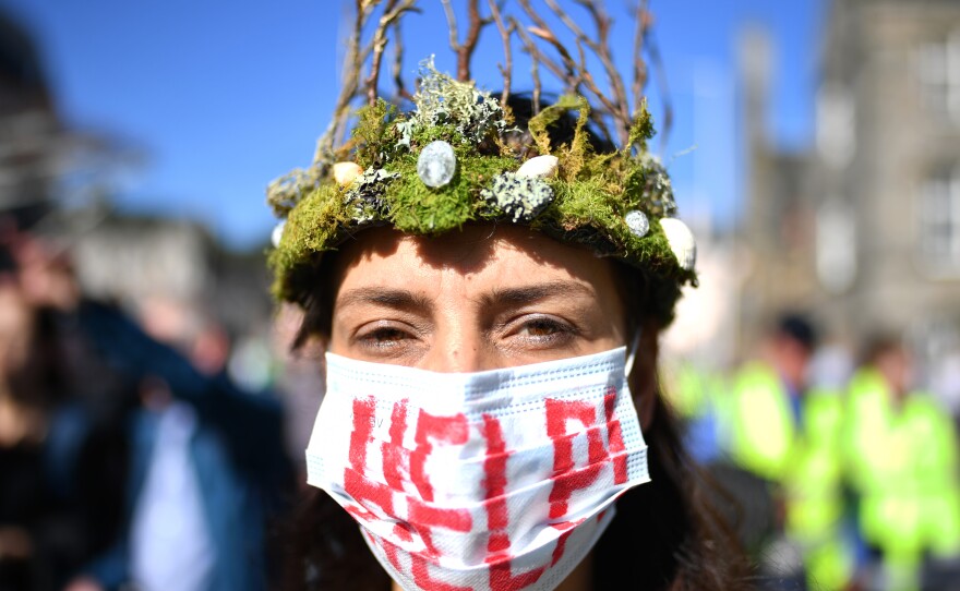 The Global Climate Strike drew scores of protesters around the world Friday, as young people answered a call from activist Greta Thunberg to demand action on climate change. Here, a protester attends a rally in Edinburgh, Scotland.