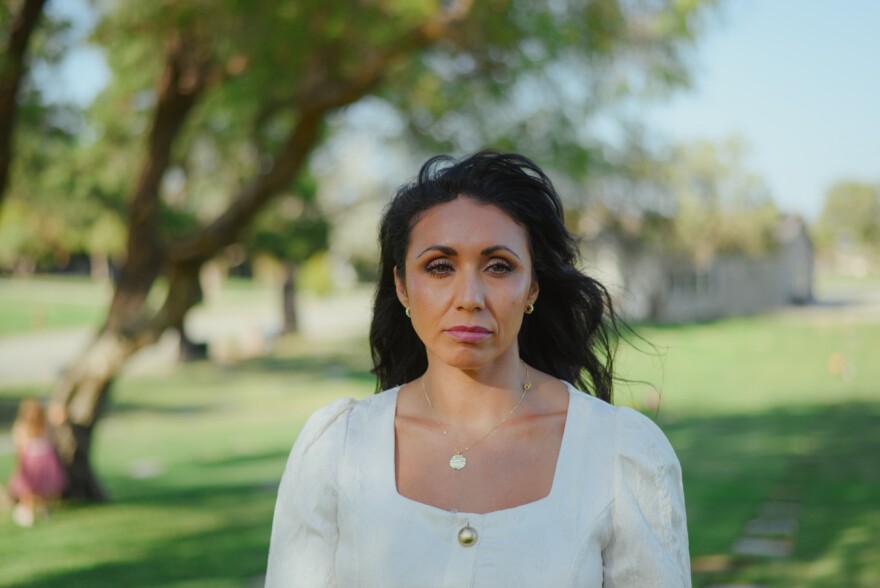 Brandie Curtis, Ciara Estrada's older sister, stands for a portrait at the Murrieta Valley Cemetery District in Murrieta, California on Oct. 4, 2025.  (Kori Suzuki / KPBS)