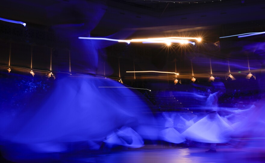Whirling dervishes perform during the ceremony.