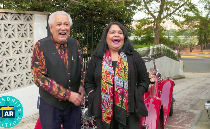 Paquito D’Rivera and Brenda Feliciano: Musicians Paquito D’Rivera (left) and Brenda Feliciano laugh outside their home. ANTIQUES ROADSHOW “Celebrity Edition, Hour 4”premieres Monday, May 24, 2021 at 8/7C p.m. on PBS.