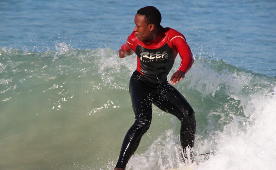 Mntanywa catches a wave at Monwabisi Beach.