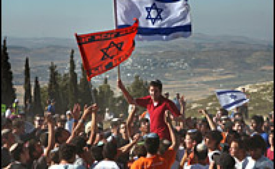 In this file photo from June 2007, thousands of Israeli settlers and right-wing activists return to the abandoned West Bank settlement of Homesh, calling for the reconstruction of the site that Israel evacuated in 2005.