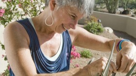 Suzi Hileman inspects an aloe on her front porch on Wednesday, Aug. 24. 