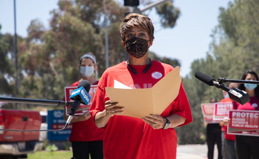 Donna Cook, a registered nurse from the San Diego VA, speaks at a rally outside of the VA Medical Center in La Jolla, May 1, 2020.