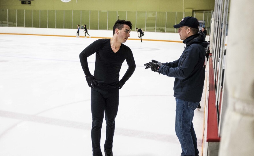 Max Aaron talks with his coach, Tom Zakrajsek, during practice at the World Arena Ice Hall in Colorado Springs.