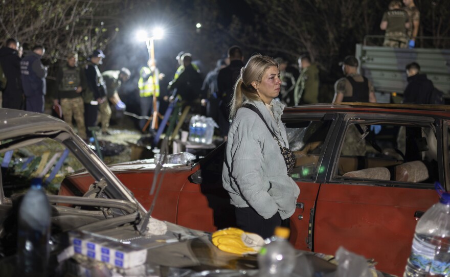 Lida Nechvolot, who lost her step-father reacts at the place of a Russian rocket attack that killed 51 people in the village of Hroza near Kharkiv, Ukraine, Thursday, Oct. 5, 2023.