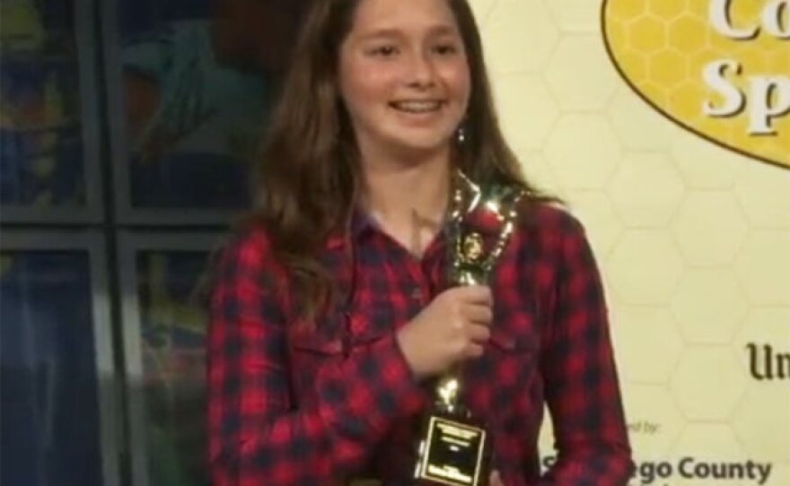 Ella Peters holds the trophy she received for winning the 47th annual San Diego Union-Tribune Countywide Spelling Bee, March 15, 2016.