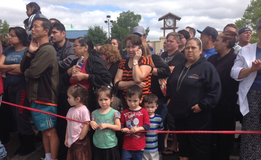 Parents and family members gather at the Cherry Park Safeway in Troutdale, Oregon.