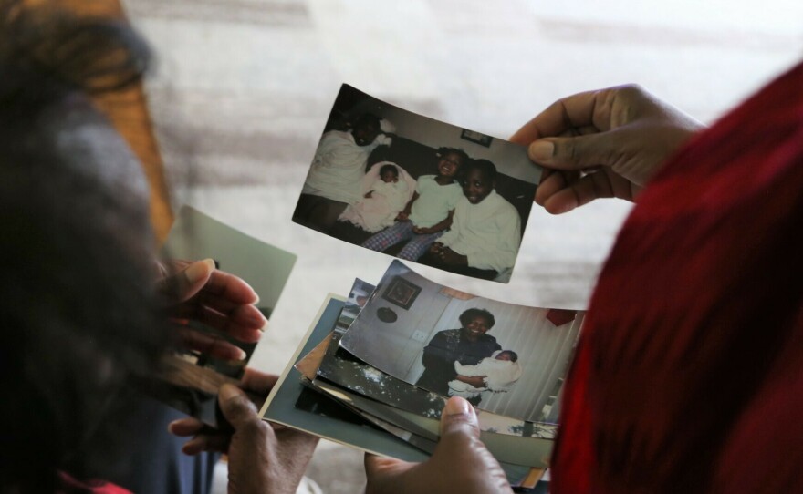 Reynolds and Lewis-Thorpe look through family photos together. Reynolds says she missed the initial signs of her mom's Alzheimer's because they lived in different cities.