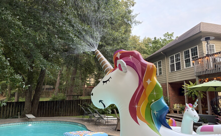A unicorn inflatable sprinkler sprays water across Jasmine Lawson's pool in Birmingham, Ala. on June 24, 2026.