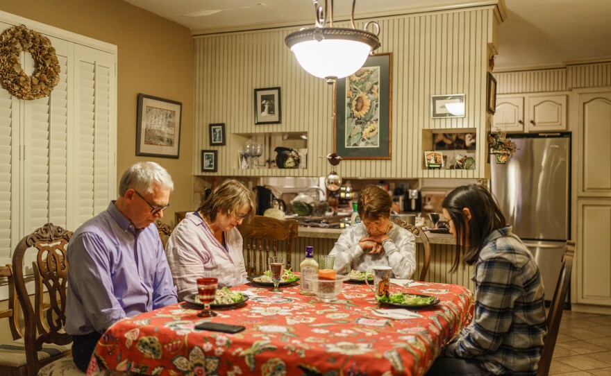 The Turners pray at the dinner table before eating at Zoe's grandmother's house.