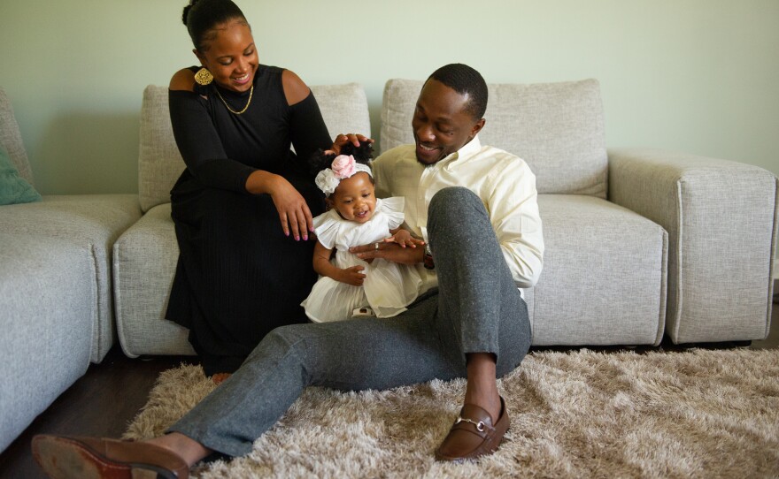 The Smith family playing in their Charlotte home. Brittany Smith and her husband both have good-paying jobs. She says she's lucky. She's the first in her family to go to college.