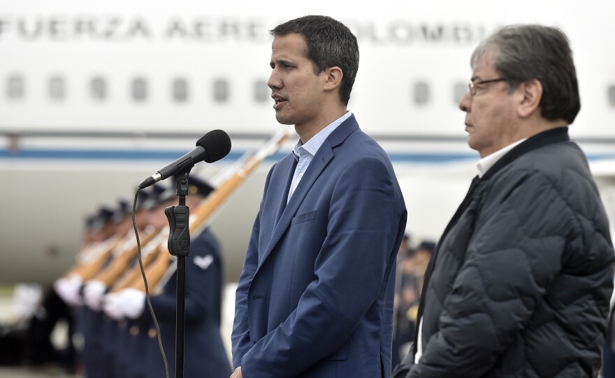 In this photo released by Colombia's presidential press office, Venezuelan opposition leader Juan Guaido makes a statement as Colombian Foreign Minister Carlos Holmes Trujillo stands by at a military airport on Sunday.