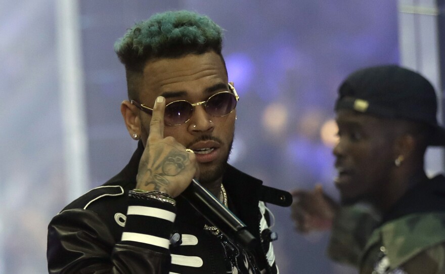 Chris Brown performs during Fashion Week last fall in Milan, Italy. The Paris prosecutor says the singer and two other individuals were arrested. Brown has been accused of rape and narcotics possession.